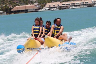 Combo Banana Boat Ride and Bumper Tube Ride in Hawaii - Banana boat tow: staying on through twists and wake crossings