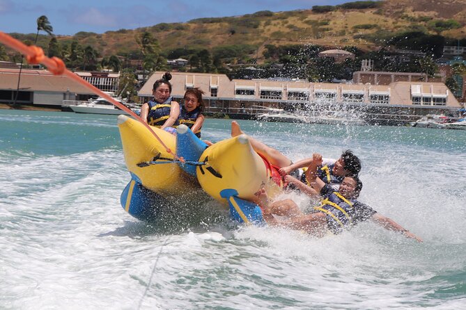 Combo Banana Boat Ride and Bumper Tube Ride in Hawaii - Bumper tube time: holding on while you cross wakes