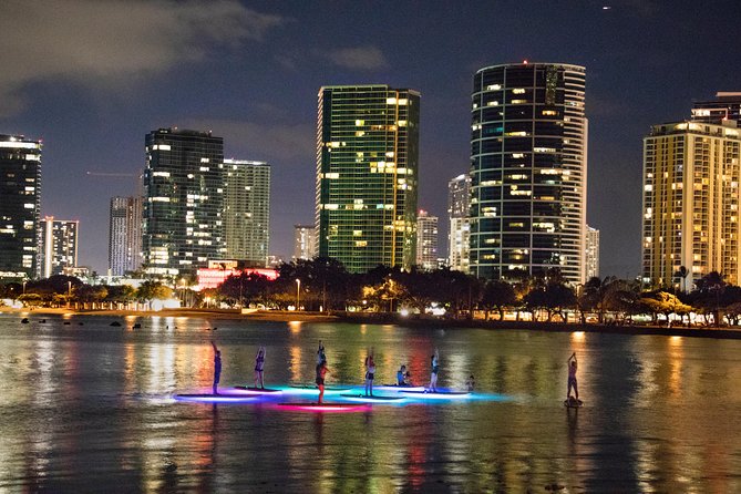 Night SUP Yoga in Honolulu, Hawaii - Views you actually paid for: lights below, skyline ahead, sky overhead