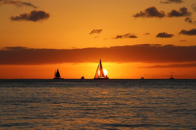 Waikiki Sunset Cocktail Cruise - Hilton Hawaiian Village - Queen’s Beach and Diamond Head Lighthouse: calmer shoreline, big presence